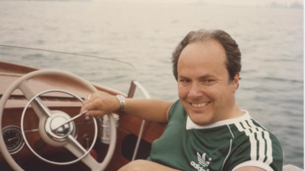 Frank Hagerty in a classic wooden boat, one of his loves and also one of the impetuses for the insurance company he founded.