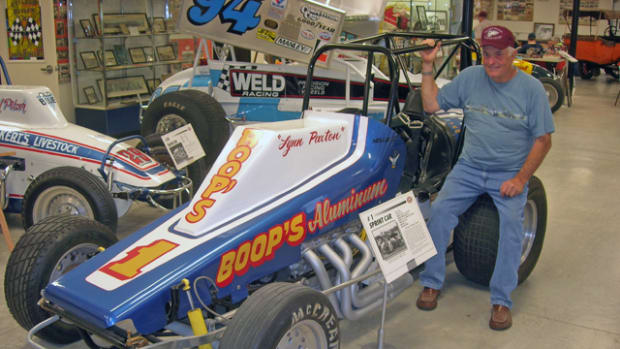 EMMR president Lynn Paxton shows off one of the sprint cars that carried him to his many victories on the rough-and-tumble Pennsylvania dirt track circuit. The sprinter is among the more than 80 race cars on display in the museum.