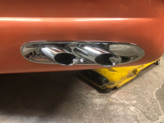 The exhaust outlet on the left lower quarter panel isn't connected to anything yet, but it will be a functional outlet when the pipes are complete below. There is a matching outlet on the right quarter.