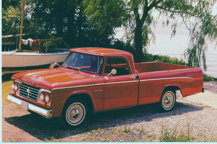 A factory photo showing the quad-headlamp 1964 Dodge D100 with the Custom Sports Special (CSS) package. Note the CSS stripes on the hood and roof, the chrome grille and bumpers and the bright molding above the cab’s windshield and door window frames.
