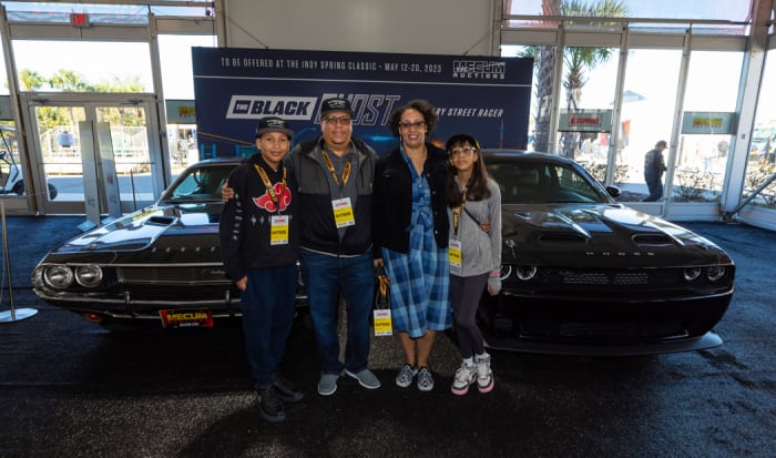 The Qualls family in front of the "Black Ghost" and the Redeye Widebody Challenger that was inspired by it.