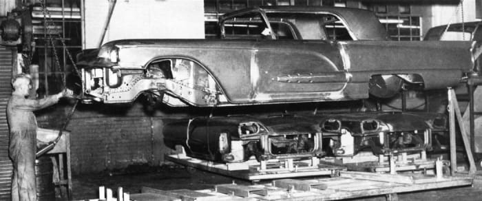 Unpainted 1959 Thunderbird coupe body travels down the assembly line.