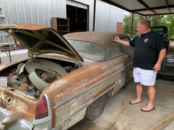 Current owner Danny Gove looks over the 1954 Lincoln Mardi Gras show car at his restoration shop in Texas. The car is intact and very solid, but the sun has weathered the paint and unique interior.