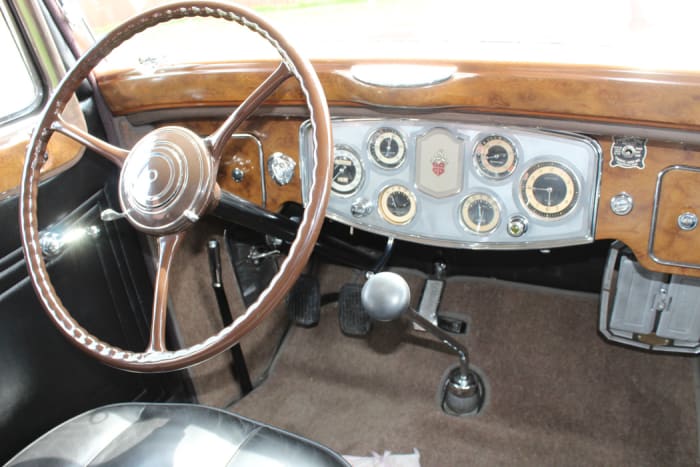 The stylish “woodgrain” dash is actually painted metal. It’s part of a luxurious interior that includes leather seats and lots of gauges that were high-tech for the time.