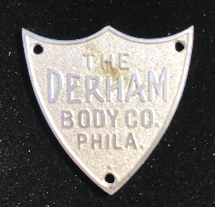 Shield-shaped Derham tag sold by Check the Oil Promotions for $300.
