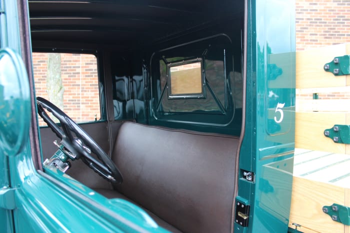 The seats and door skins are brown vinyl with the sheet metal painted the same green as the exterior.