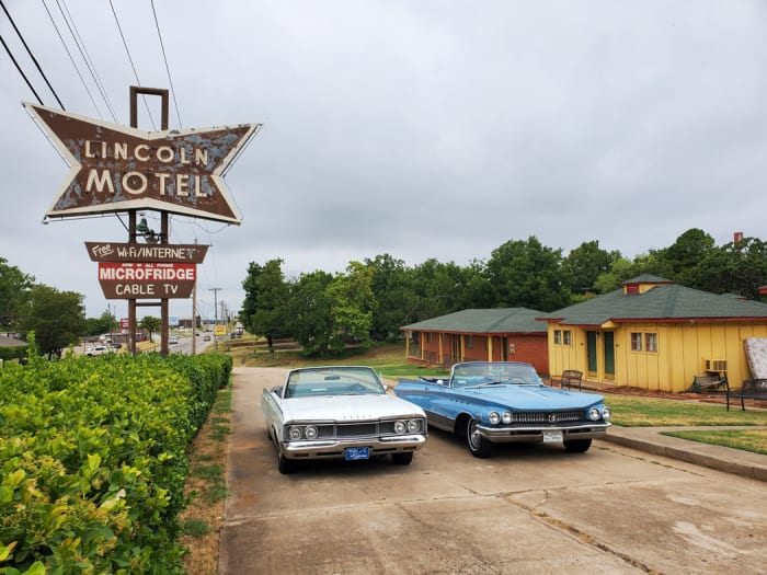 Jim Jordan’s 1960 Buick Electra 225 convertible and Ryan Richards’ 1968 Dodge Polara convertible as they set out for Detroit, after a stop at the Lincoln Motel in Chandler, Okla., and its great, old sign.