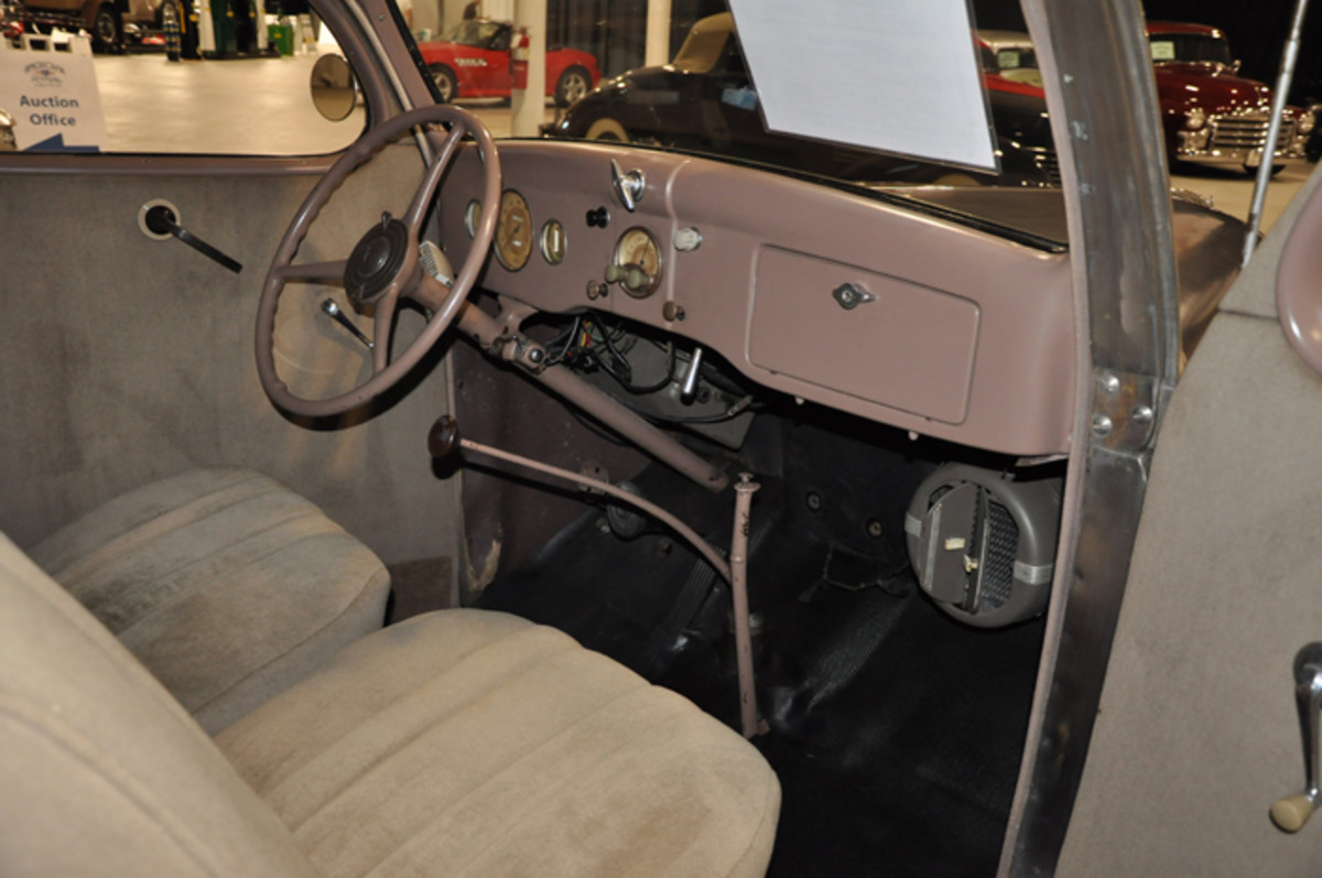 The interior of the 1936 Ford reveals it has a factory radio as well as an under-dash heater. As a safety feature, aftermarket turn signals have been added.