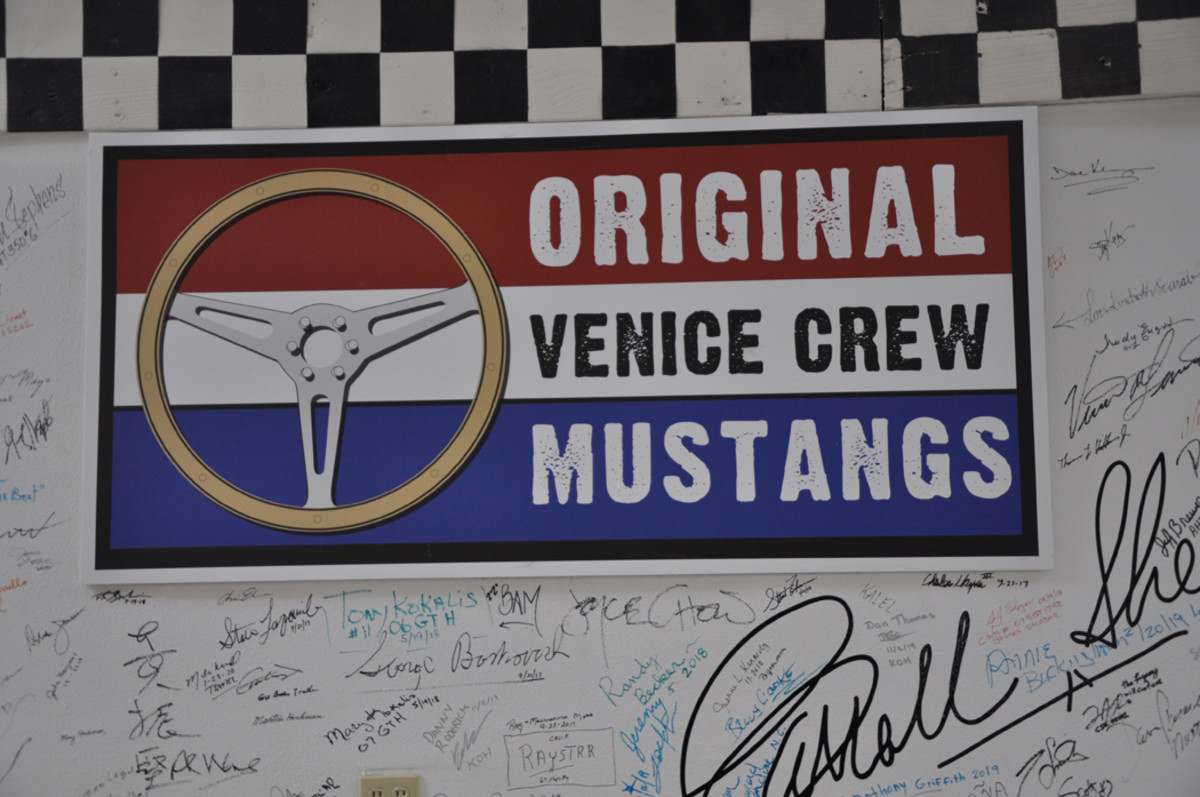 The official logo of the Original Venice Crew adorns one wall of their Gardena shop with signatures from owners and those involved in this and other Shelby projects.