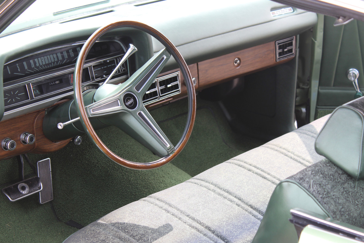An automatic on the tree, air conditioning, woodgrain trim and a bench seat with pleated green upholstery right out of your grandmother’s living room are just a few of the refinements in this Torino’s interior. The Rim-Blow steering wheel is off the Torino options list for ’71.