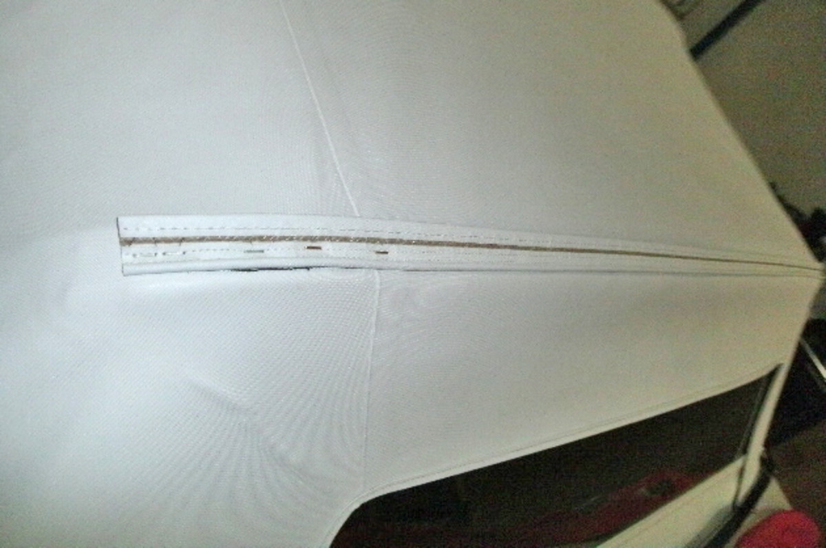 Once the top is centered and the wrinkles were removed, “wire on” was attached to the rear bow to cover the staples that attach the top to the rear bow. The “wire on” was then folded over the staples and hammered smooth with a rawhide hammer.