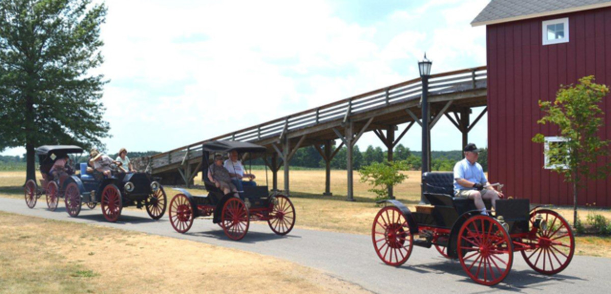 A parade of very rare high wheel motor buggies—true horseless carriages—built between 1895 and 1915 will be showcased and driven during the Red Barns Spectacular car show. During the infancy of the automobile, some states passed Red Flag laws, requiring a person to carry a red flag and walk ahead of each car to warn others on the road. (Photo courtesy Gilmore Car Museum)