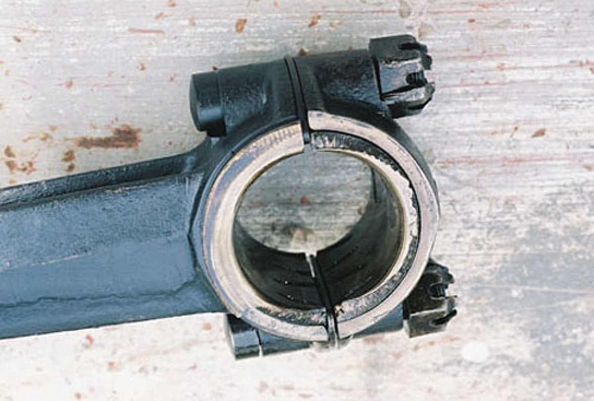 A connecting rod had sustained damage to its babbitt bearing, evidenced by the chipping along an edge. The cause initially was unknown. One small piece had fallen into the oil screen and was still resting there, out of harm’s way. The damage may have been due to the soft metal alloy (tin, lead, copper and antimony) which created less friction under use