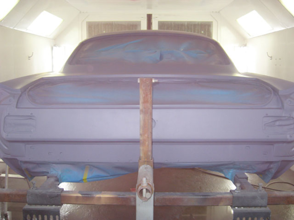 Between spraying the base coat and primer, a tinted sealer was sprayed on the body. It appears pink here.