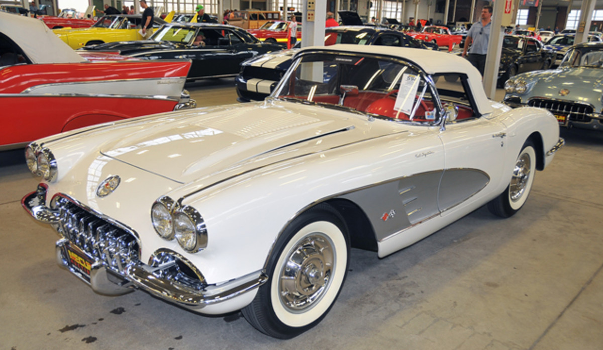 A Snowcrest White 1958 Corvette with silver coves, a white soft top and a red interior sold for $137,500.