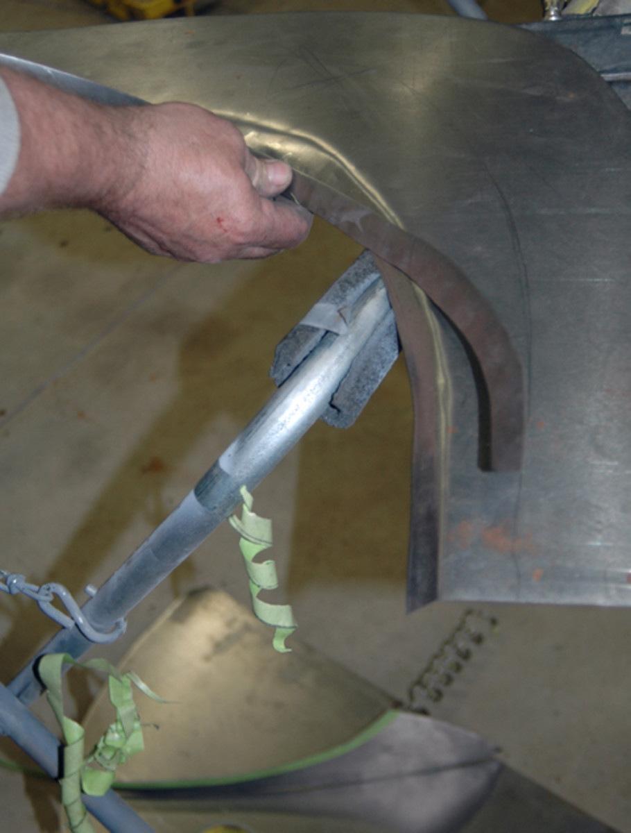  Schrock lines up the two metal pieces he fabricated — the outer quarter panel patch and the lip inside the wheelwell — and determines where they should be welded together. Once they’re in the ideal position, he draws a line from one panel to the other, indicating where they should be tack welded in place.