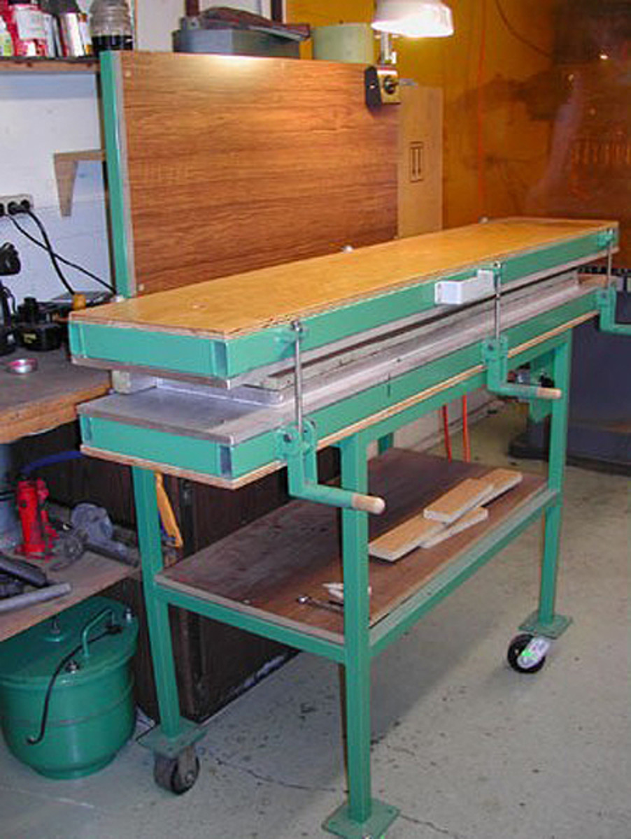  Above, When the metal core is place, the heated top platen can be lowered and turned on. This machine applies both heat and pressure. Below, Twenty minutes later, the urethane has solidified into a solid, rubber-like substance and is ready to be removed. Note how the rubber is now vulcanized to the core.