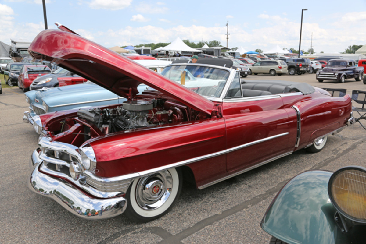The candyapple red paint dripping off the sensuous curves of Syl and Shirley Szucsko’s 1950 Cadillac Series 62 convertible guaranteed the drop top to be as popular as Marilyn Monroe at a pool party.