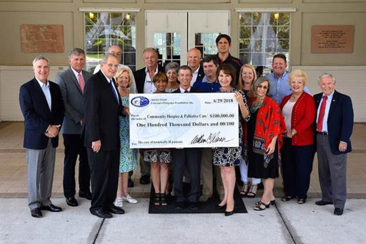  Amelia Board, volunteers and staff members gathered with the leadership of Community Hospice and Palliative Care to present a check for $100,000.