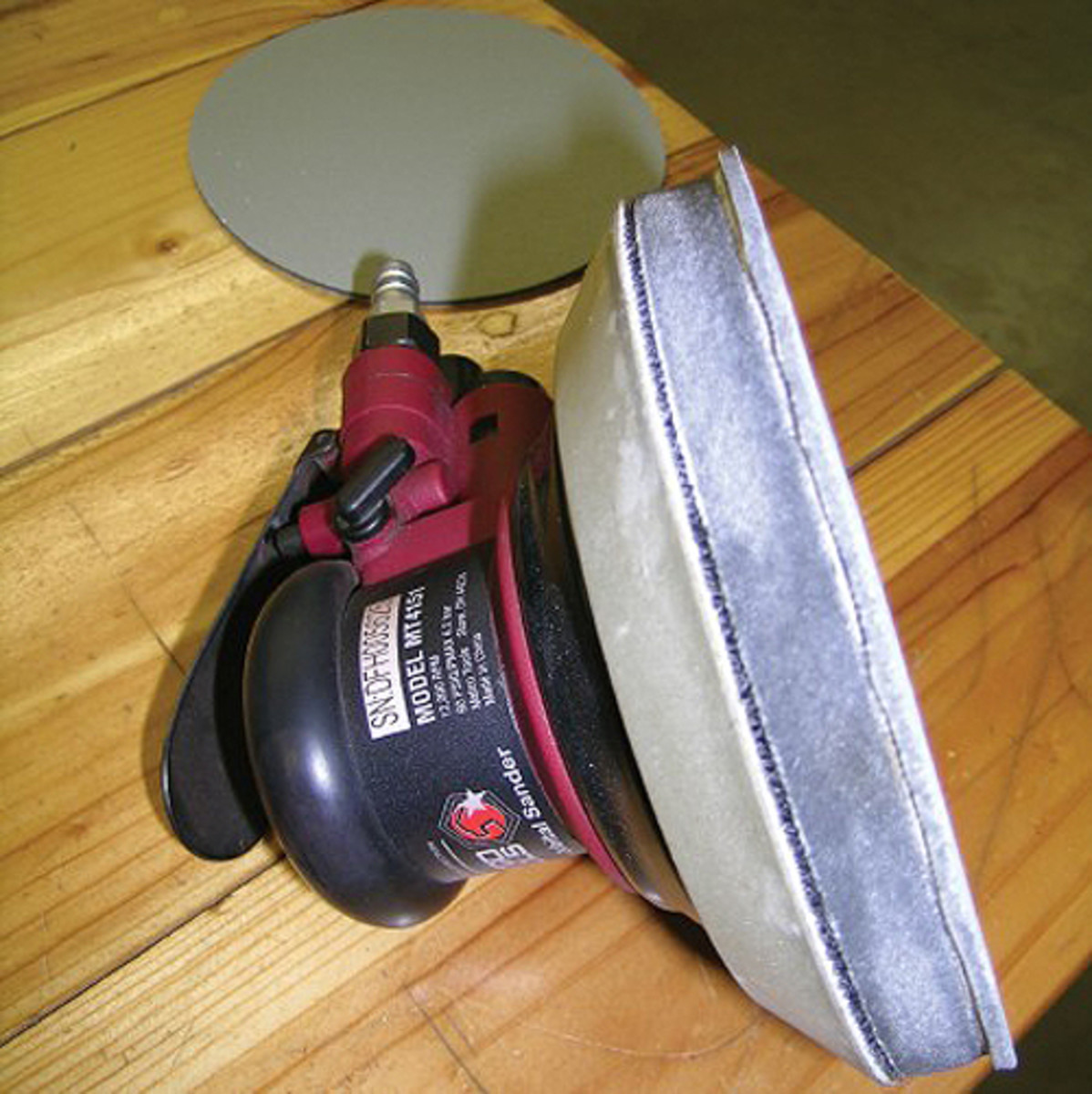  Once he works through 800-, 1,000-, 1,200-, 1,500- and 2,000-grit sandpaper using sanding blocks, Kopecky switches to a random orbital sander for sanding with a 3,000-grit disk. He installs a thick pad beneath the 3M Trizact 3,000-grit sanding disk so the pad flexes without digging into the paint while he sands with medium pressure at a low to medium speed.