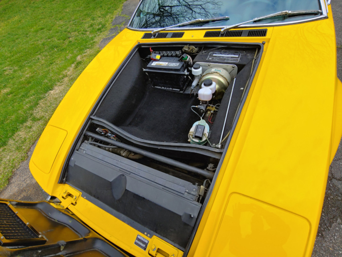  simple panel over the top of the air cleaner cover is all that separates the driver and passenger from the 351-cid Ford V-8 mounted mid-ship. The battery and some plumbing is located in front under the hood, along with a small storage area.