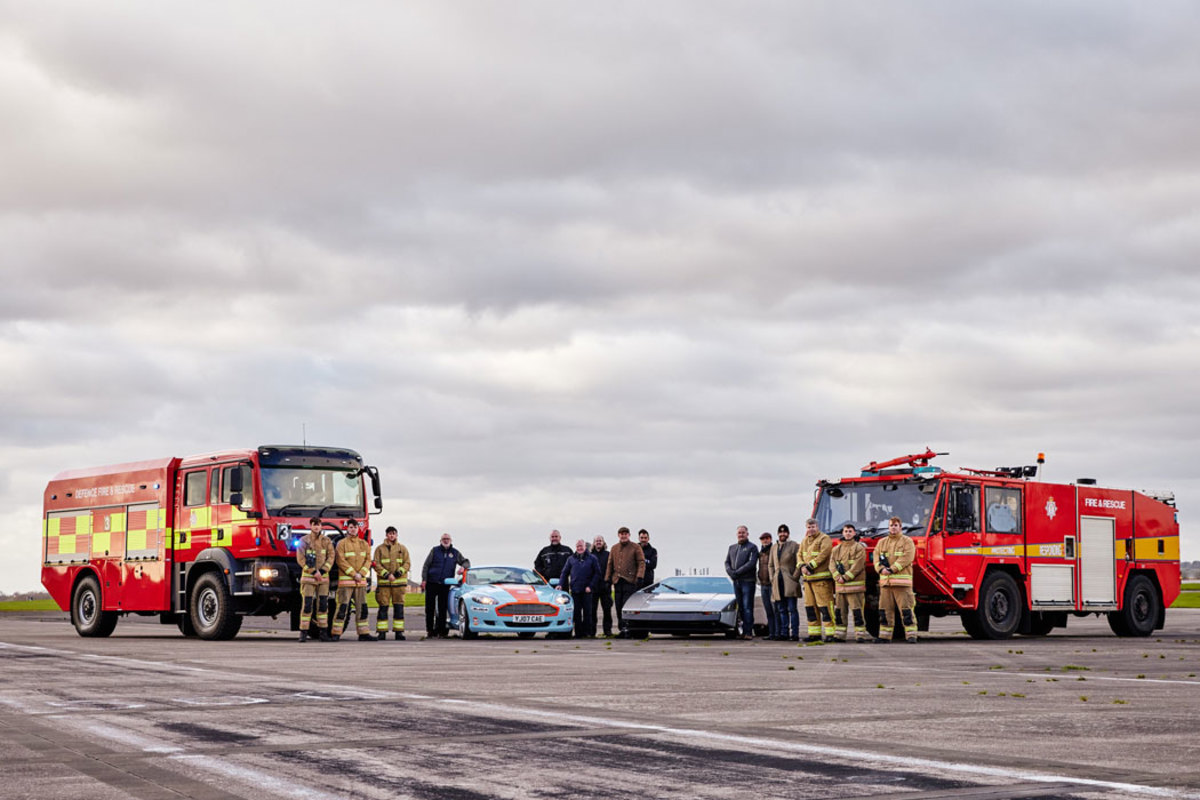 Royal Naval fire fighters, Royal Naval staff, and the CMC team pose with Bulldog and An Aston Martin DB9 used as chase car on the day.
