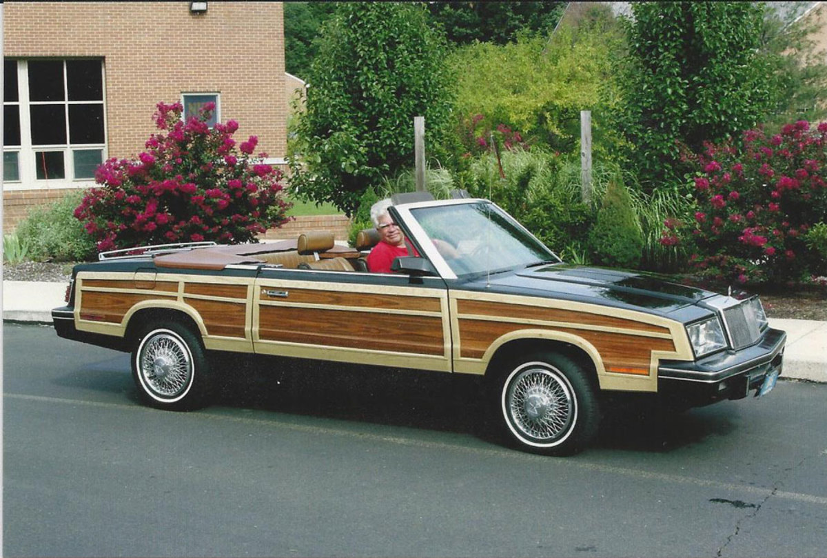Terry Golda with the top down and enjoying hitting the road in the Lebaron Town & Country.