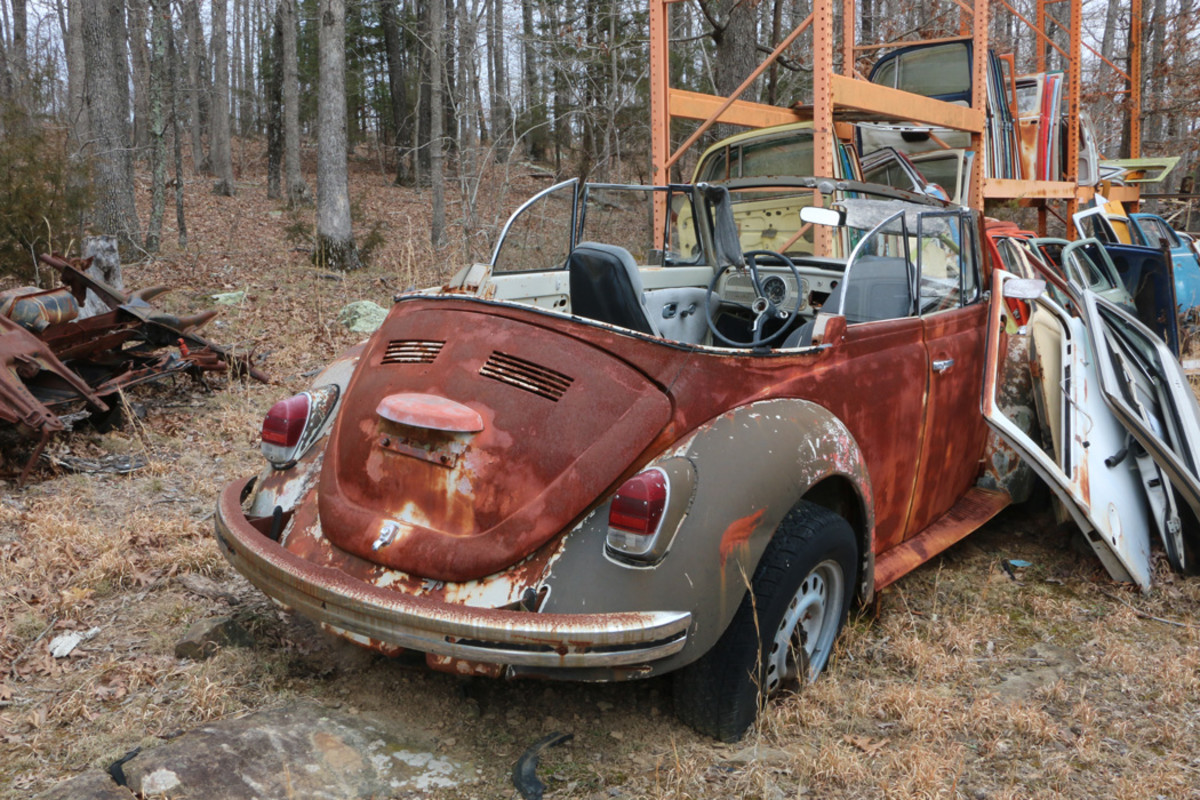 This ’68 Beetle convertible has been in the yard for about 10 years. There is a metal rack in front of it loaded with doors that are in good condition, and are ready to ship.