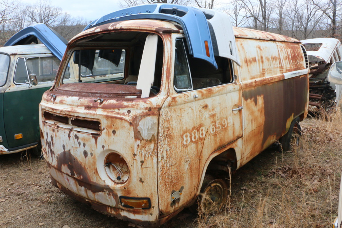 There are a few panel vans in the yard, including this 1970 model with rusty floors.