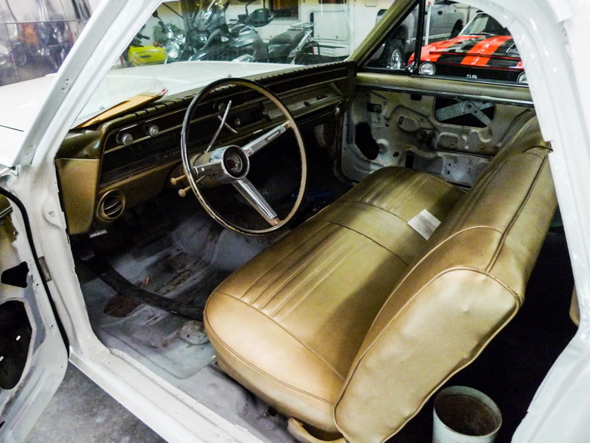 Here, on the inside, the original bench seat is restored with NOS coverings. For future reference, the worn original trim is safely preserved in storage.