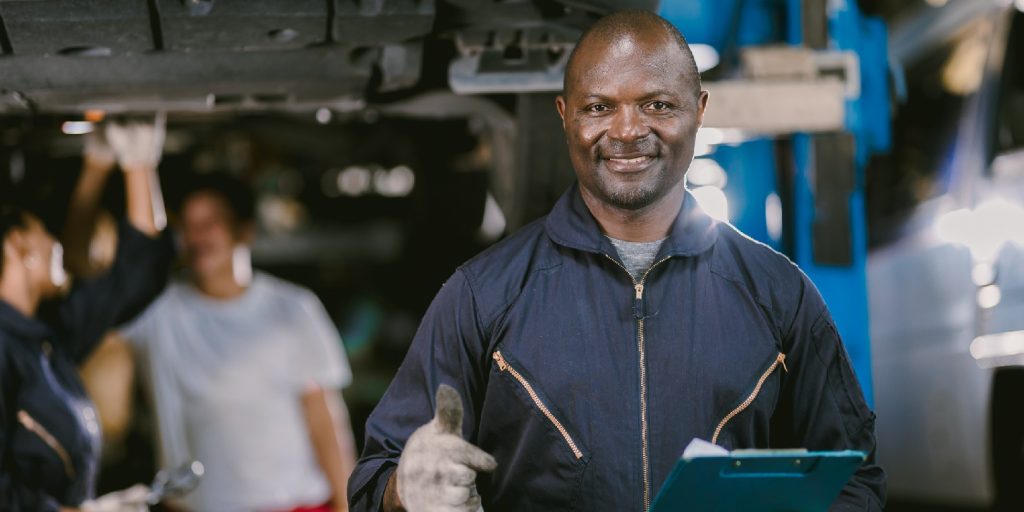 video Portrait Black African mechanic garage worker check auto service team staff smart standing happy smile