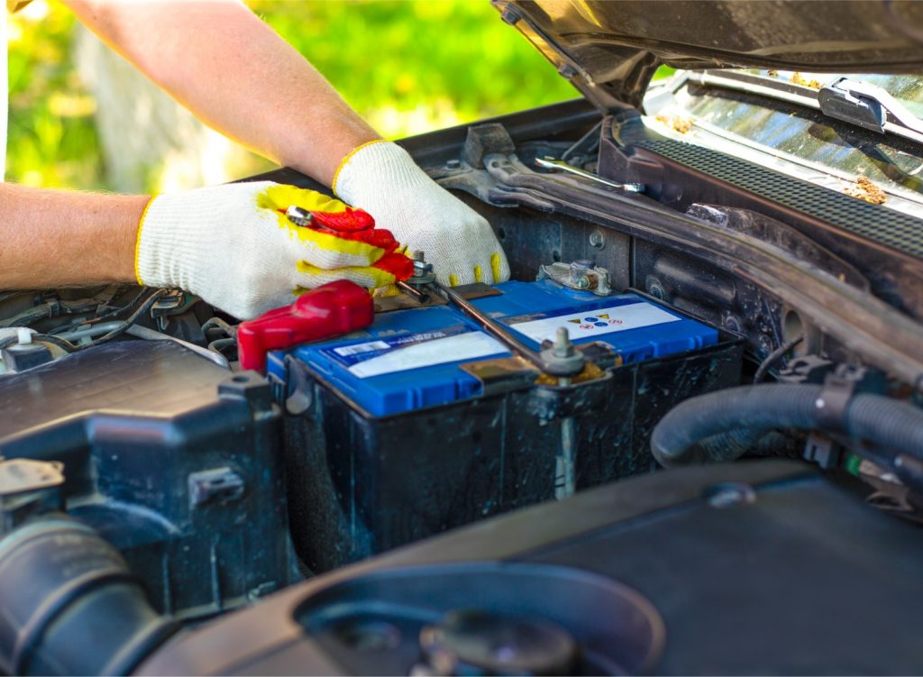 Person putting in a car battery