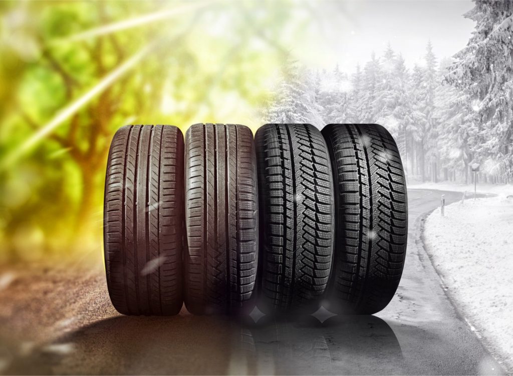 Tires on a summer and winter background