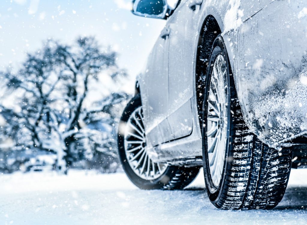 Close up of car tires driving in the snow
