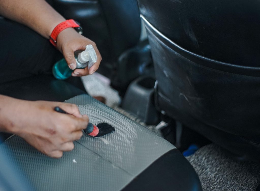 Man cleaning a leather car seat