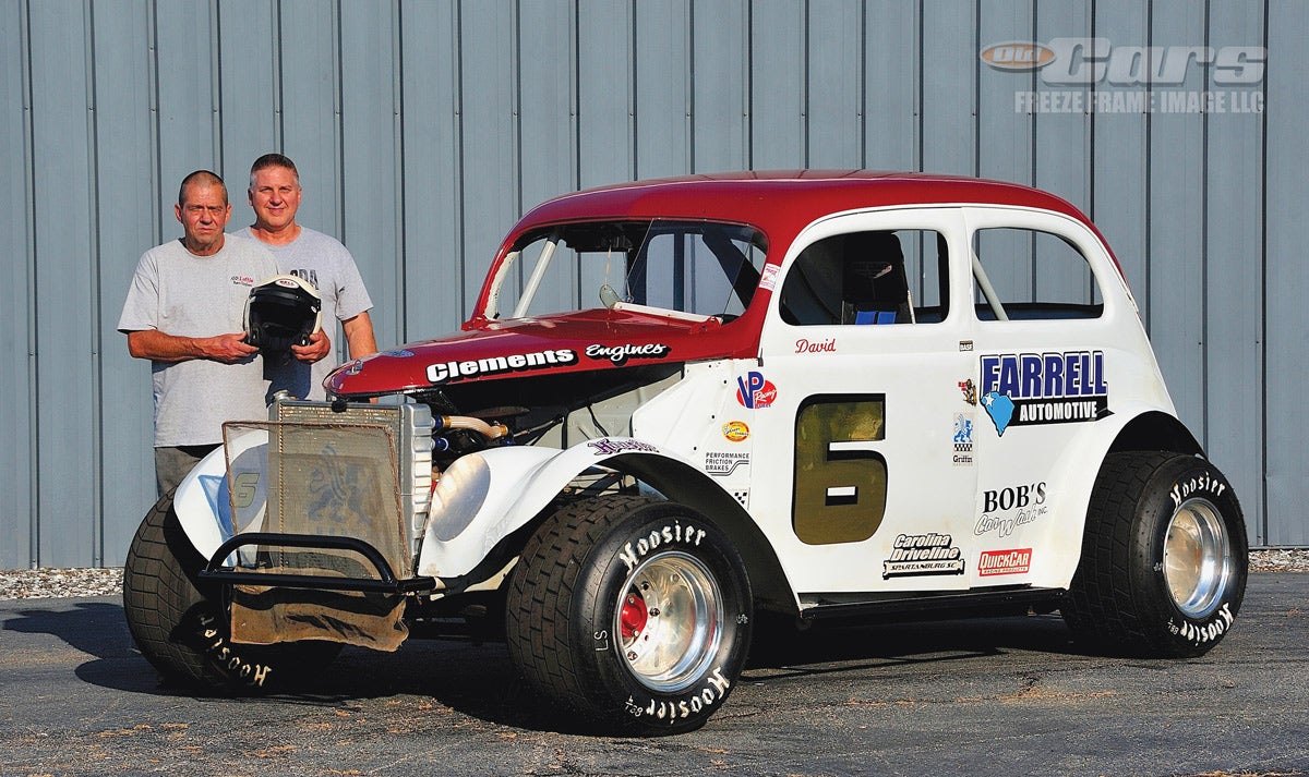 Larry Martin (holding David Person’s original race helmet) and Eddie Pearson with the 1937 Ford race car.