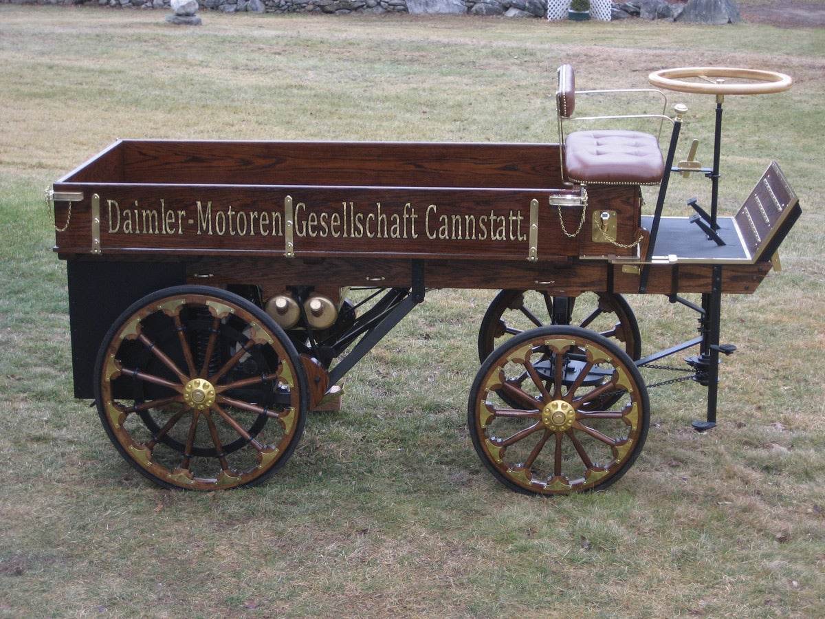 Side view of 1896 Daimler reproduction shows two different wheel sizes used.