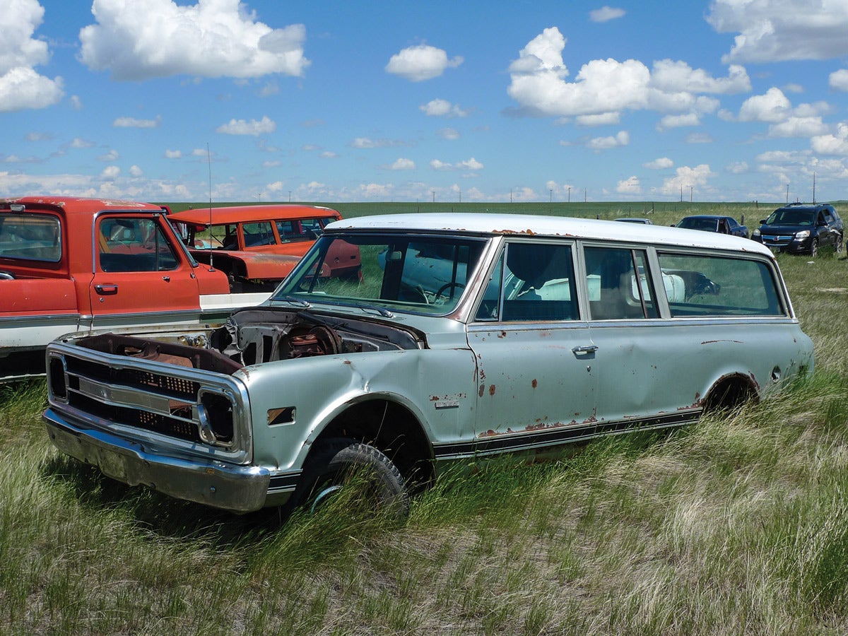 Surrounded by parts donor pickups, doesn’t this shell of a ’70 Suburban deserve a second chance?