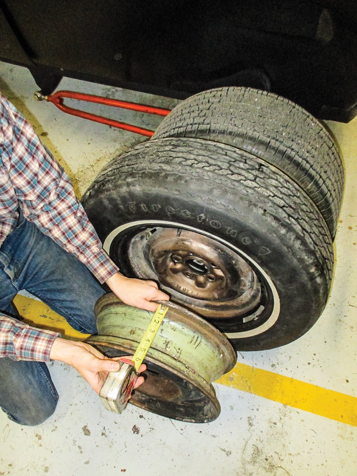 In the foreground is a 1954-’56 Chevy wheel. It’s 15x5, and it would work for the rear. In the background is a 1950-’56 Ford wheel. Apart from their bolt pattern differences, the two look very much alike.