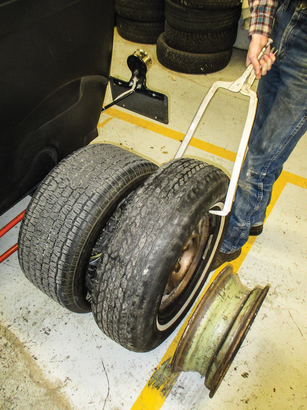 The Ford wheel still has a raggedy old tire mounted. For width comparison, this clumsy clamp doubles as a precision instrument in a pinch. This wheel’s rim is 5 inches wide as well.