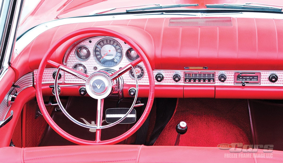 The instrument panel cluster for the 1957 Ford Thunderbird was recycled from the full-size 1956 Fords, but with a different engine-turned face. This T-Bird sports the optional Town and Country radio.