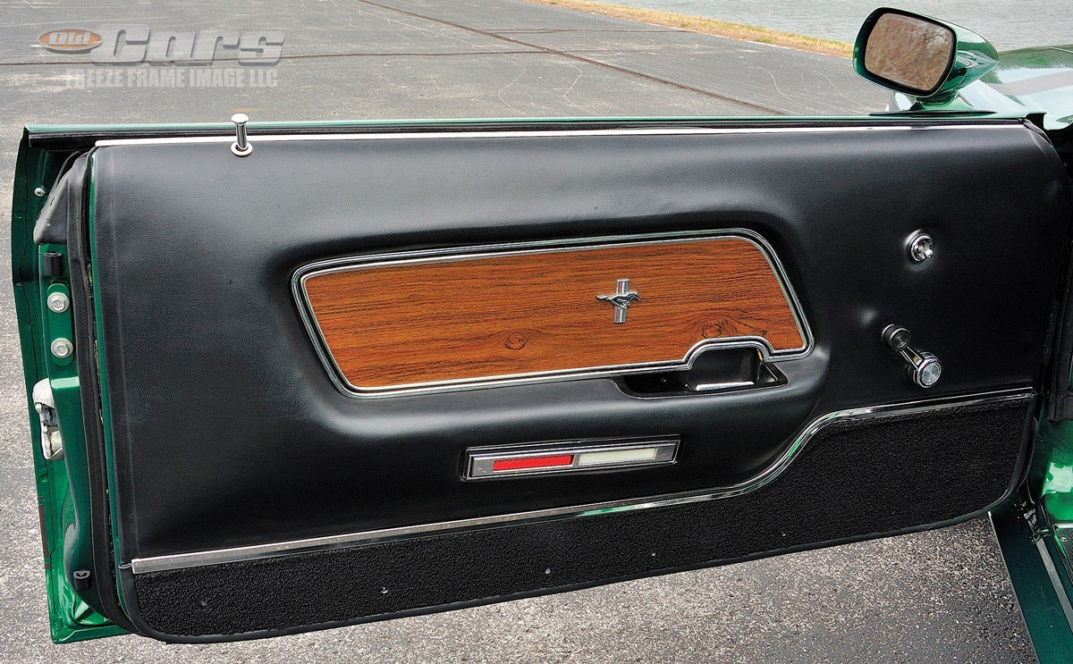 Deluxe 1970 Mustang door panels, as in the featured Boss 302, added the wood applique and silver trim running the length along the bottom.
