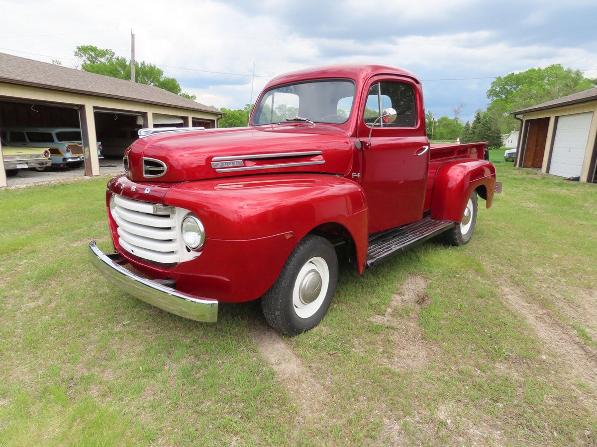 1949 Ford F1 pickup:
1949 cherry red Ford F1 pickup. Roger’s favorite! Powered by an FH V8 engine with manual transmission. Odometer shows 70,057. The interior is black bench and has a heater, AM radio. 

