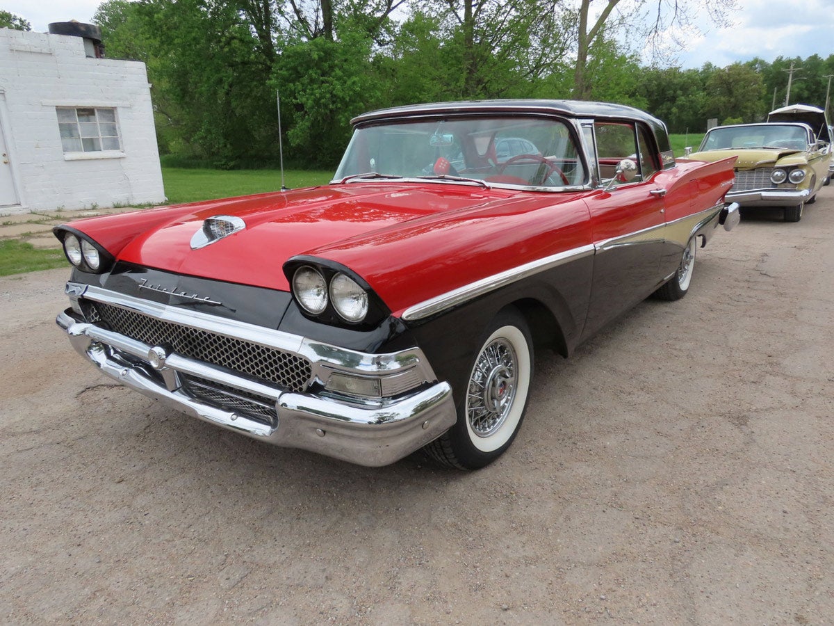 1958 Ford Fairlane: 1958 red and black Ford Fairlane 500 Skyliner with a retractable hardtop, fully restored, runs and drives, powered by an Interceptor 352 V8 engine with automatic transmission, 73,662 miles.