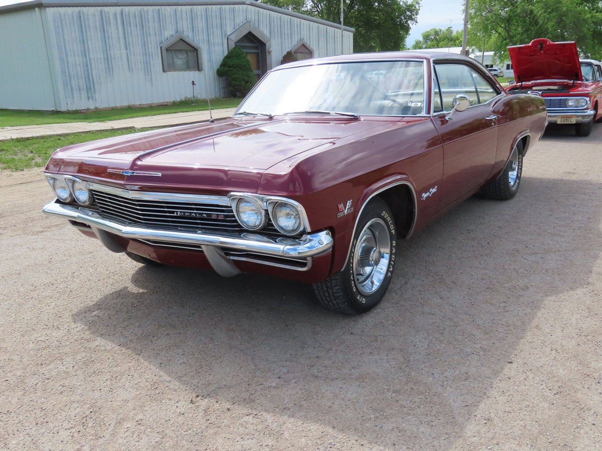 1965 Impala SS: Restored maroon 1965 Chevrolet Impala SS, runs and drives, rally rims, powered by a 396 V8 with 4bbl carb, 4-speed manual transmission with Hurst shifter. Odometer shows 100,995 miles.