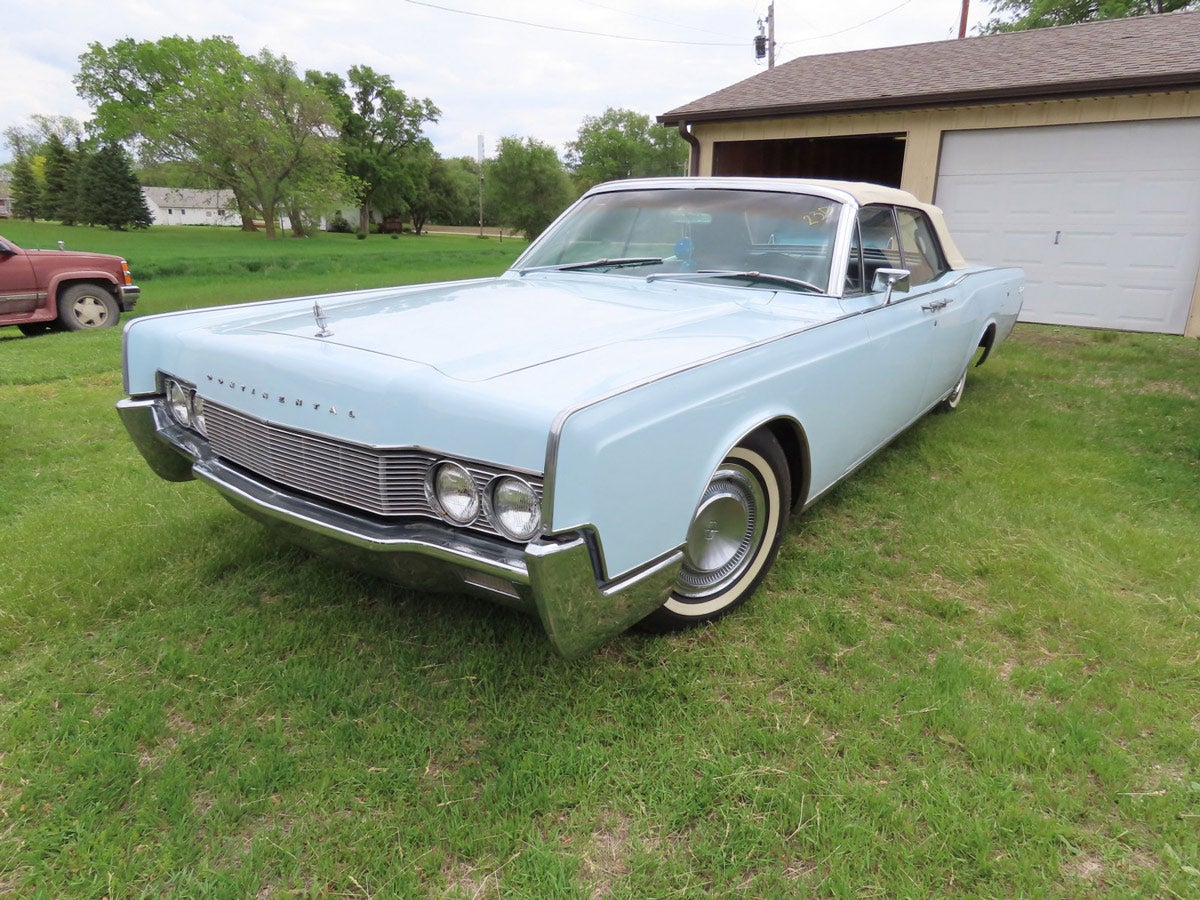 1967 Lincoln Continental: Baby blue 1967 4-door Lincoln Continental convertible with suicide doors and white top, powered by a 462 V8 engine with automatic transmission. The odometer shows 75,257 miles.