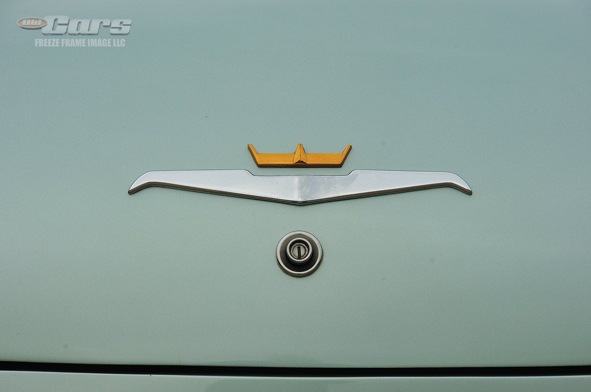 The deck lid emblems include a Chrysler crown above a highly stylized falcon shape. These emblems are repeated above the grille.