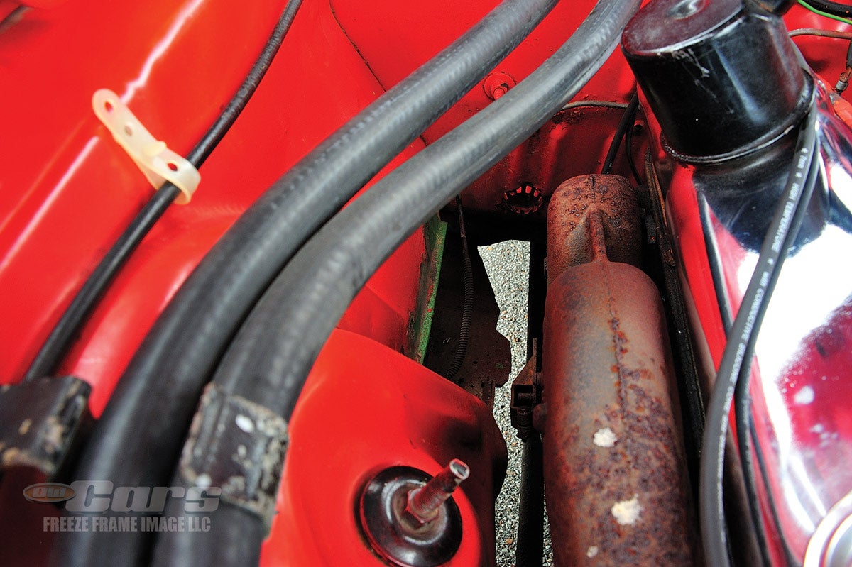 Traces of the Daytona prototype’s original green paint from its early life can still be seen in the engine compartment (center of image).
