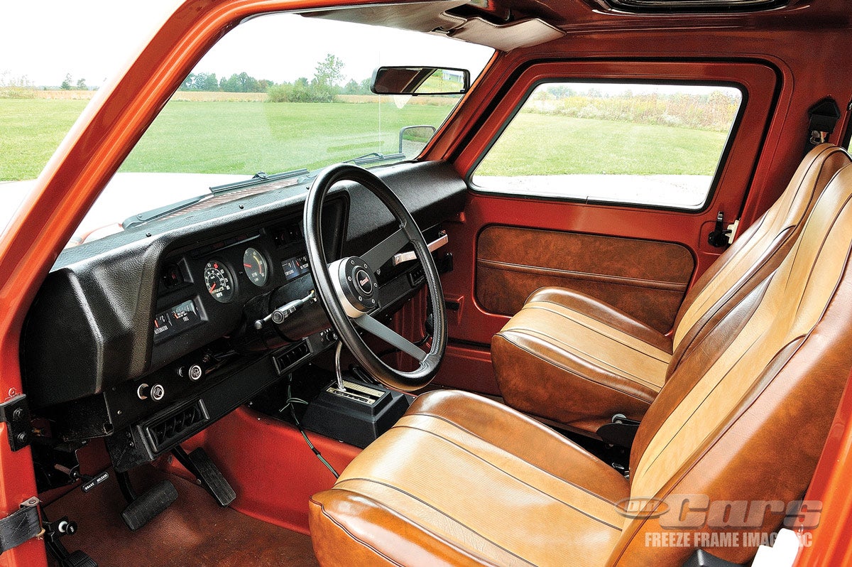 The interior is a mix of the exposed composite body material and two-tone brown and tan vinyl upholstery.