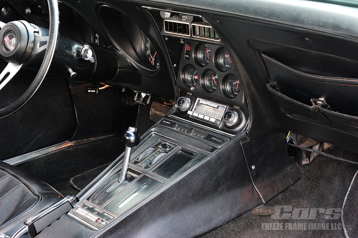 The automatic shift handle is nestled in a wide console with a full complement of gauges above it.